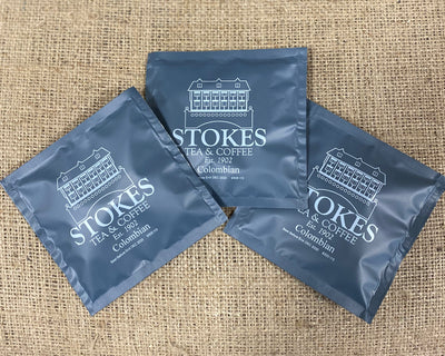 3 coffee bags on top of a hessian sack