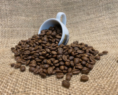 Colombian Coffee Beans pouring out of Stokes Espresso Cup