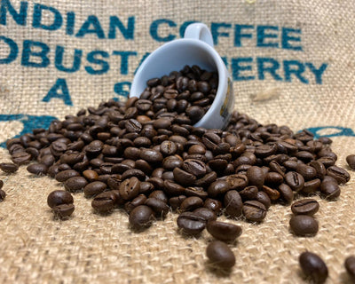 Italian Roast Coffee spilling out of a Stokes Espresso Cup