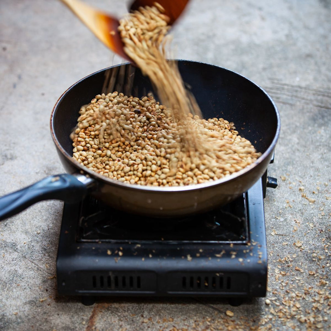 Green Coffee Beans being added to pan