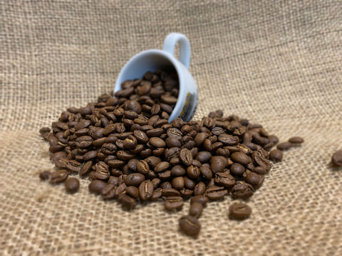 Colombian Coffee Beans pouring out of Stokes Espresso Cup