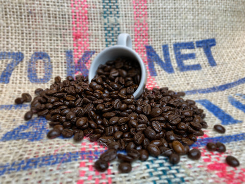 Continental Coffee Beans spilling out of an espresso cup