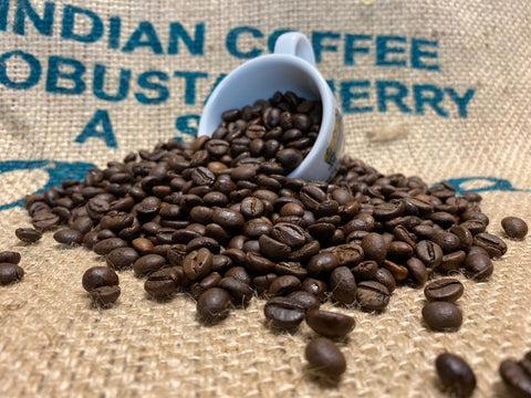 Italian Roast Coffee spilling out of a Stokes Espresso Cup